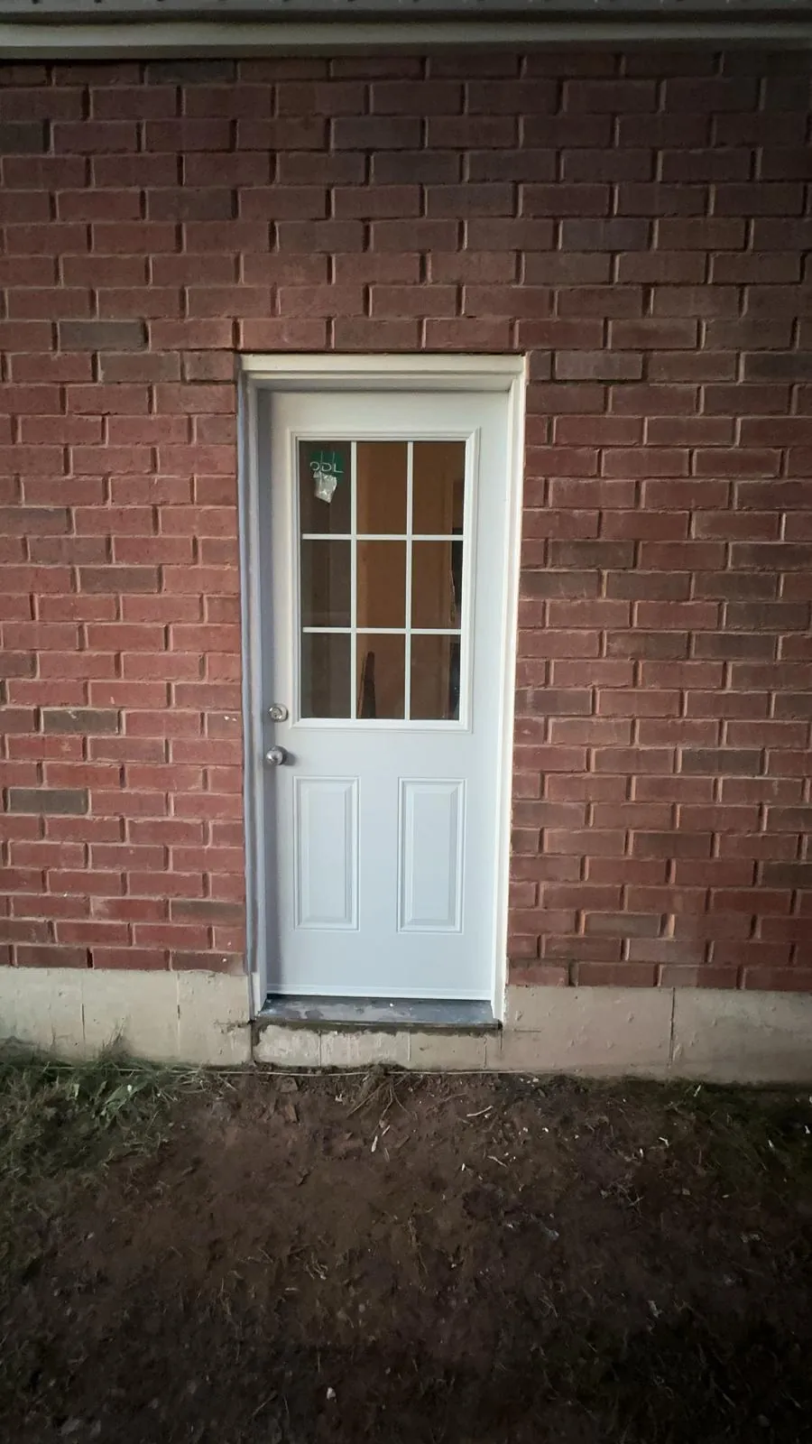 New basement door — brick wall